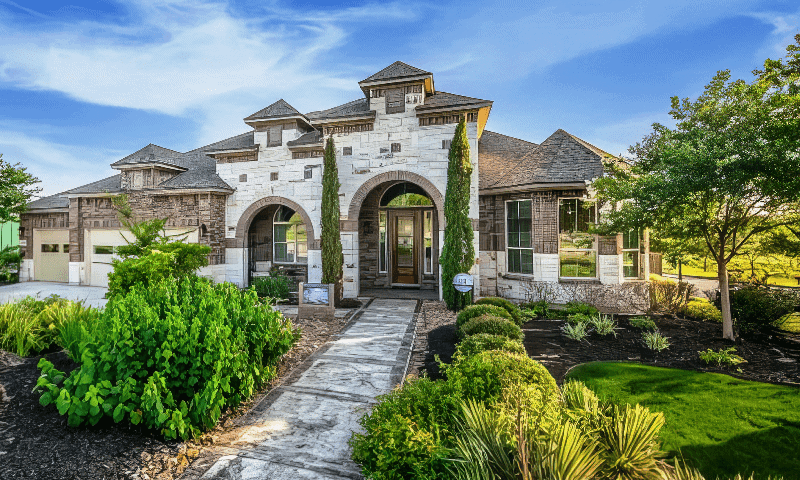 Beautiful home with pruned trees and maintained yard in Castroville, TX