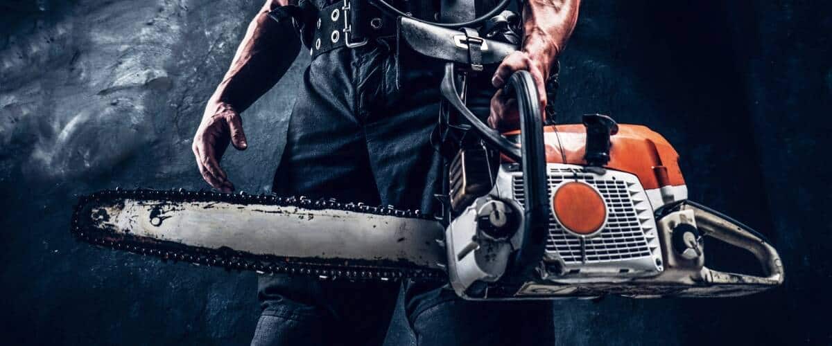 An arborist holding a chainsaw