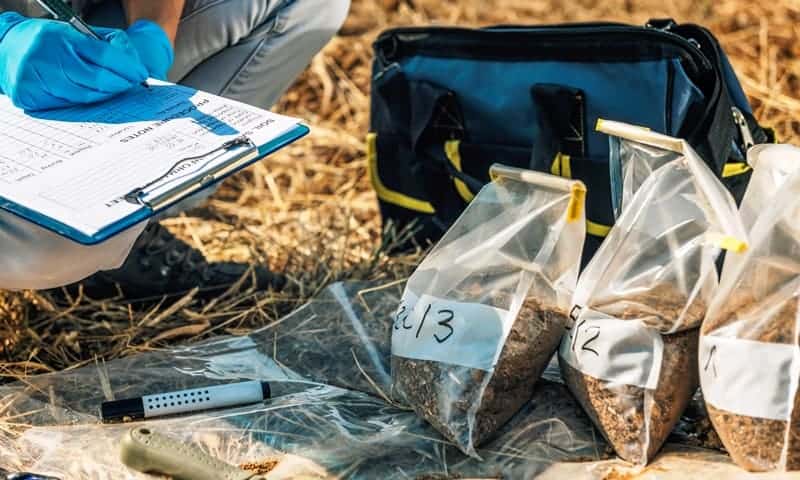 Tree care specialist documenting soil samples taken from residential property