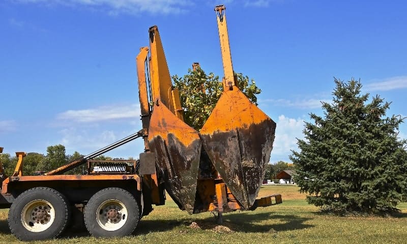 Large truck spade being used to relocate large tree
