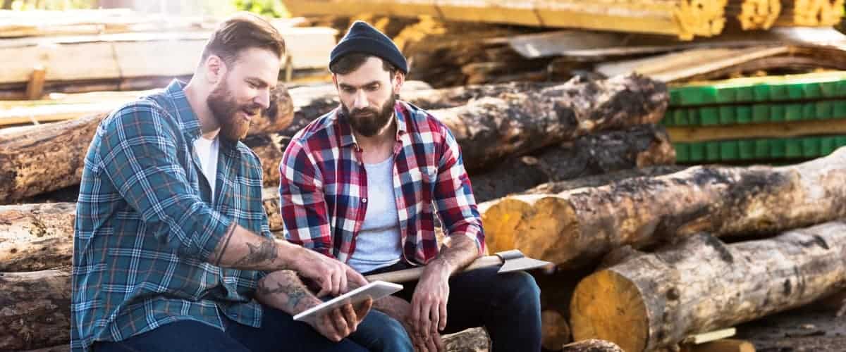 Tree workers sitting down discussing a project